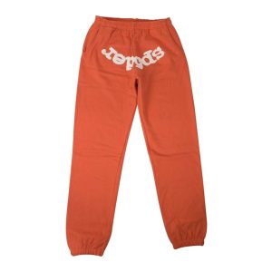 Model in a hip setting wearing the orange Sp5der Worldwide × Young Thug Sweatpants